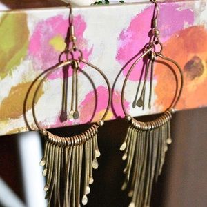 Golden tinted earrings, with fringe on bottom.
